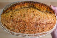 Close-up of freshly baked artisan sourdough bread with a golden crust texture.