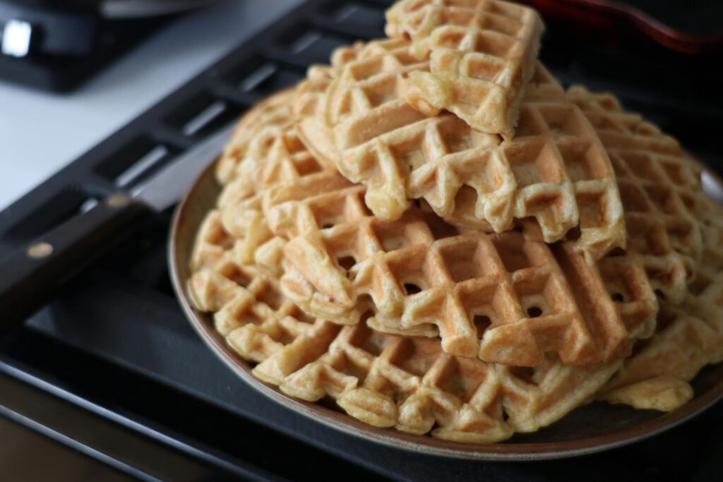 A close-up view of freshly made waffles on a plate, ideal for breakfast.