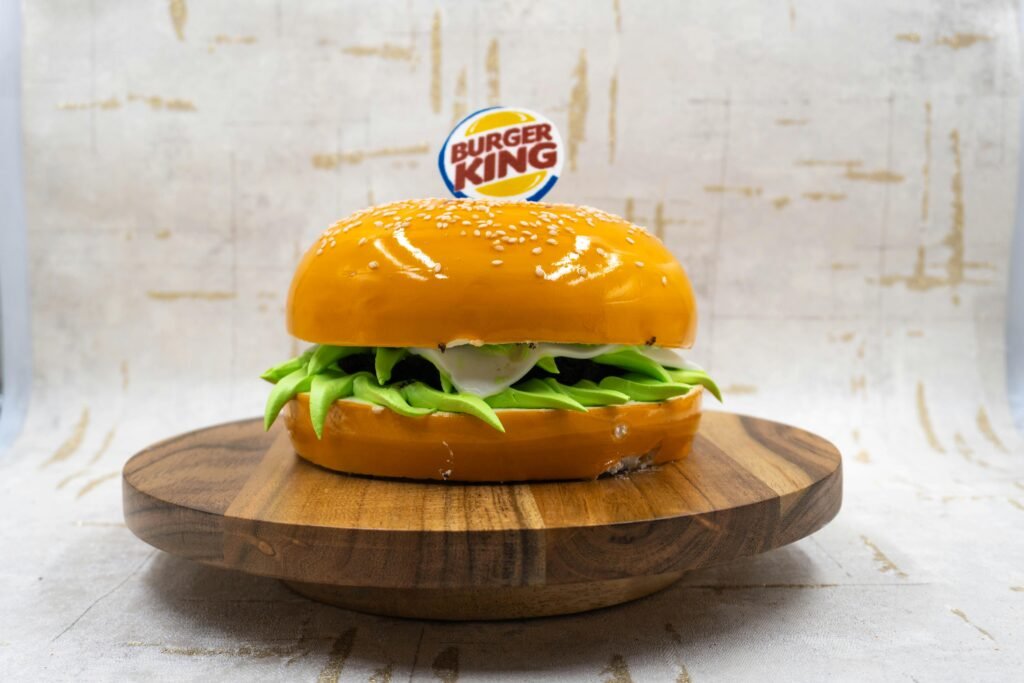 A hyper-realistic cake resembling a Burger King burger, showcasing creativity and artistry, perfect for novelty cake ideas.